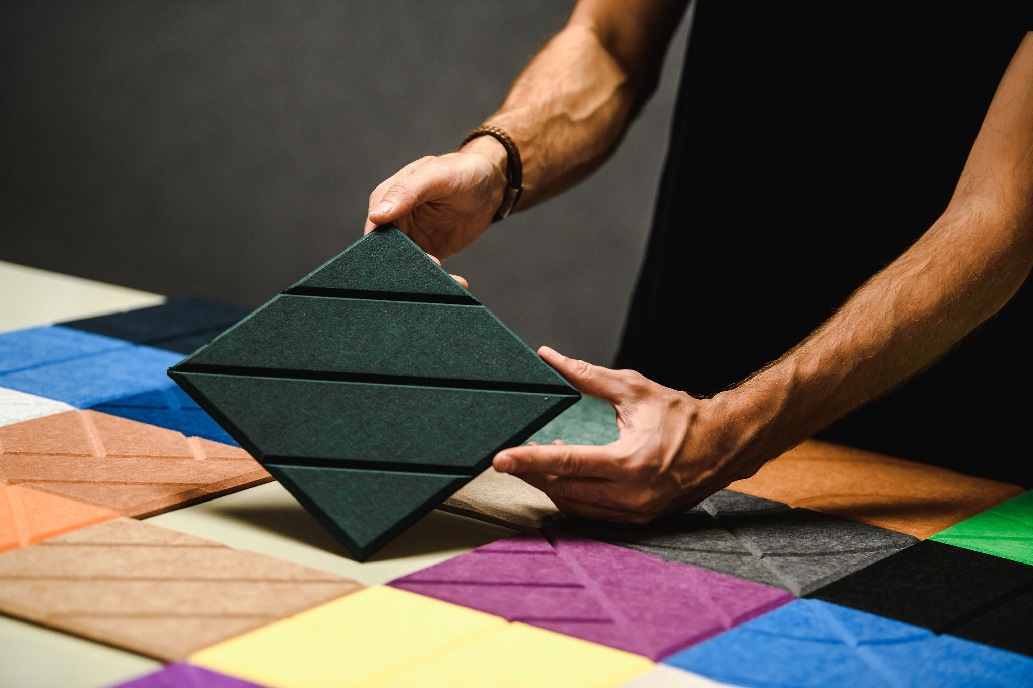 Acoustic panel in green PET-felt among panels in other colours